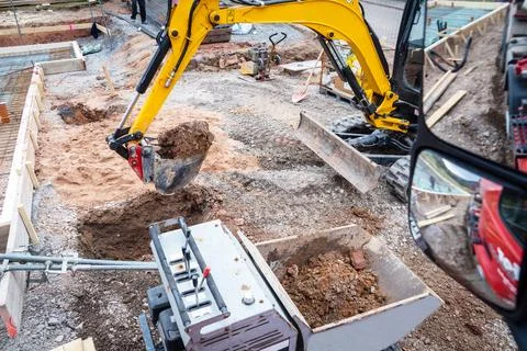 Mini excavator for moving soil on a construction site Stock Photos