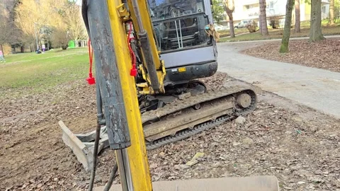 Mini excavator parked on a construction site, close-up. 库存影片 332174171