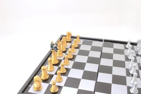 A mini of figure on the chessboard Stock Photos