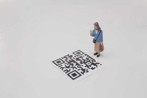 A mini figure screen the 2D bar code Stock Photos