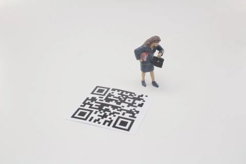 A mini figure screen the 2D bar code Stock Photos