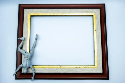 Mini figure try to escape from the frame, comfort zone concept Stock Photos