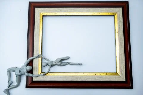 Mini figures try to escape from the frame, comfort zone concept Stock Photos
