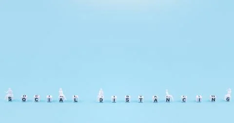 Mini figurine model sitting on letter dices keep social distancing because of Stock Photos