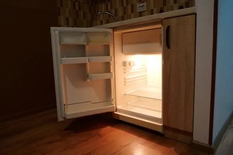 Mini fridge with open door in kitchen Stock Photos