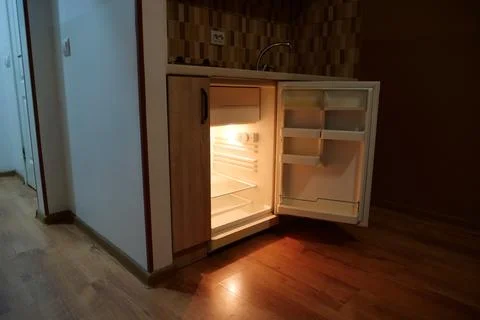 Mini fridge with open door in the kitchen Foto stock