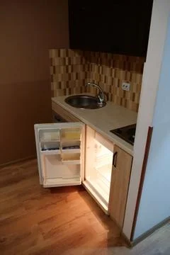 Mini fridge with open door in the kitchen Photos