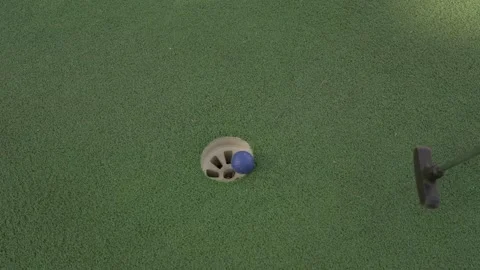 Mini golf ball hole put in hole Stock Footage 272805097