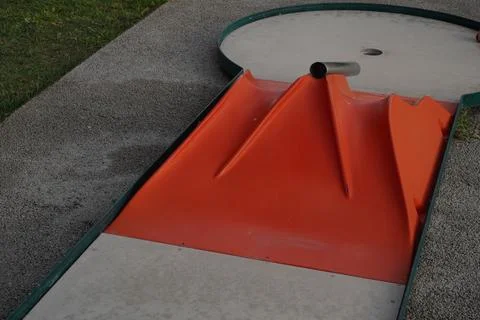 Mini Golf Course Obstacle with Orange Ramp and Hole. Stock Photos