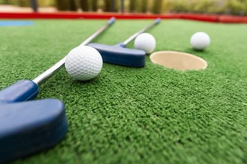 Mini golf. Playing mini golf with red ball. Recreation game 스톡 사진