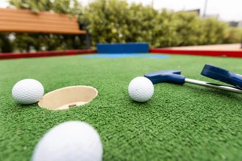 Mini golf. Playing mini golf with red ball. Recreation game Stock-Fotos
