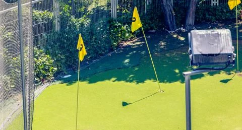 Mini golf practice in town with green and flags Stock Photos