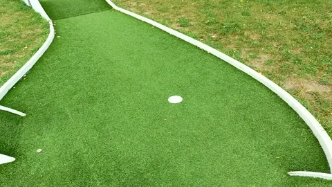 Mini golf putting green with hole and rails, clean b roll Stock Footage 320380409