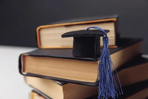 Mini graduation hat on stack of books Stock Photos