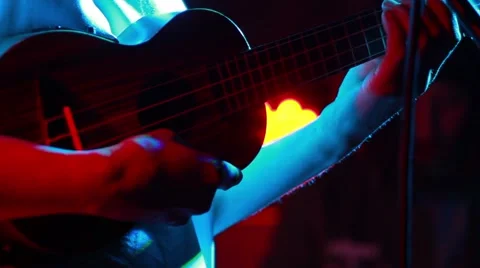 Mini guitar in hand on a beautiful background Stock Footage 51582697