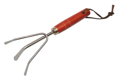 Mini hand rake ripper. Garden tool cultivator isolated on white background... Photos