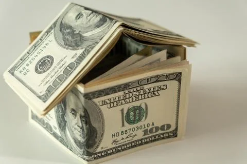 Mini house of dollars banknote. Concept of Investment property, Mortgage concept Stock Photos