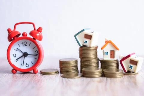 Mini house model and stack of coins. Business risk management. Property inves Stock Photos