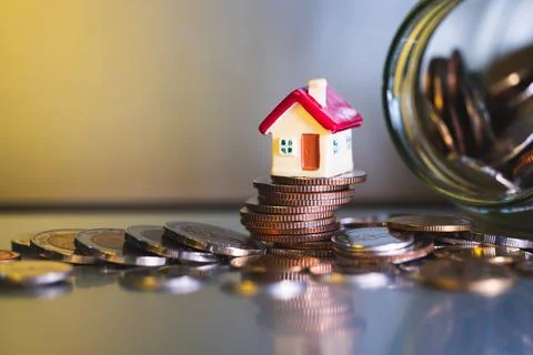 Mini house on stack coins Stock Photos