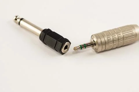 Mini-jack connector with adapter on a white background Stock Photos