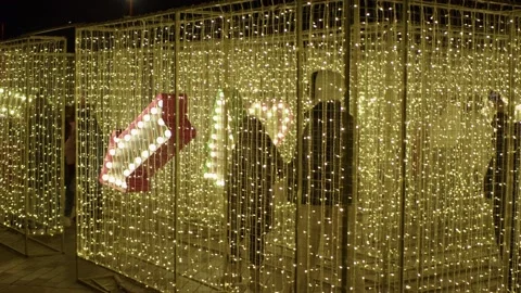 Mini labyrinth of luminous hanging garlands is installed where people can walk Stock Footage 228757482