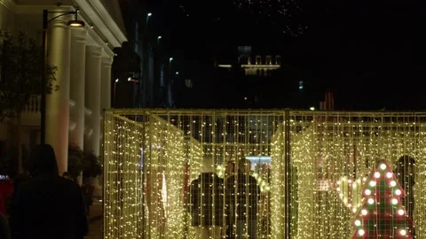 Mini labyrinth of luminous hanging garlands is installed where people can walk Stock Footage 228757941