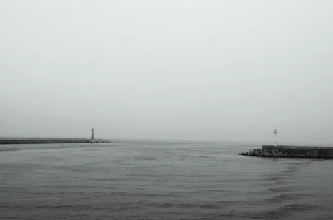 Mini Lighthouses on the coast. Two small lighthouses on the pier. Black and w Stock Photos