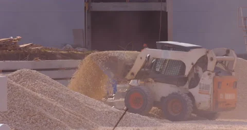 Mini loader bobcat transports crushed stone to different construction places Stock Footage 161958328