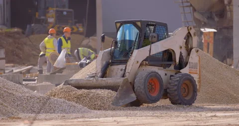 Mini loader bobcat transports crushed stone to different construction places Stock Footage 161958589