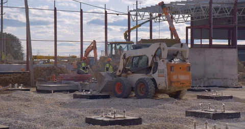 Mini loader bobcat transports crushed stone to different construction places Stock Footage 161959618