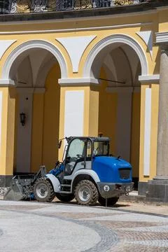 Mini Loader in Courtyard of Baroque Architecture Stock Photos