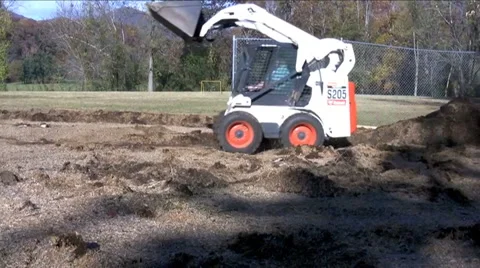 Mini loaders pushing dirt Stock Footage 926886