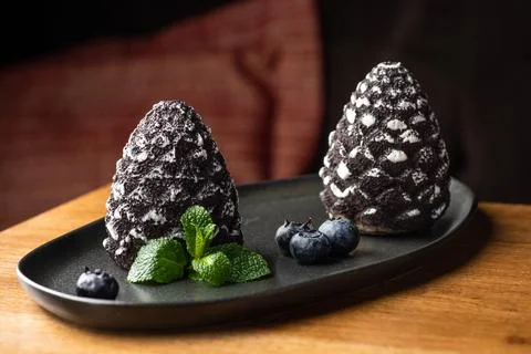 Mini-mousse dessert in the form of a pine cone, covered with velor. Modern Eu Stock Photos