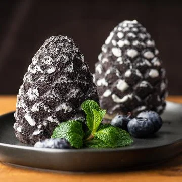 Mini-mousse dessert in the form of a pine cone, covered with velor. Modern Eu Stock Photos