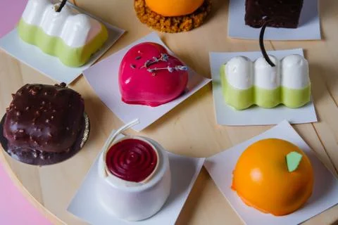 Mini mousse pastry dessert covered with mirror glaze. Modern european cake. F Stock Photos