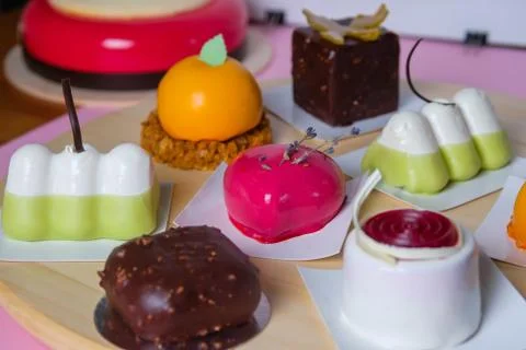 Mini mousse pastry dessert covered with mirror glaze. Modern european cake. F Stock Photos