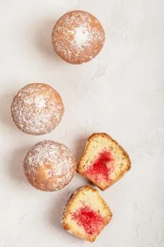 Mini Muffins with cherry jam on a textured background Stock Photos