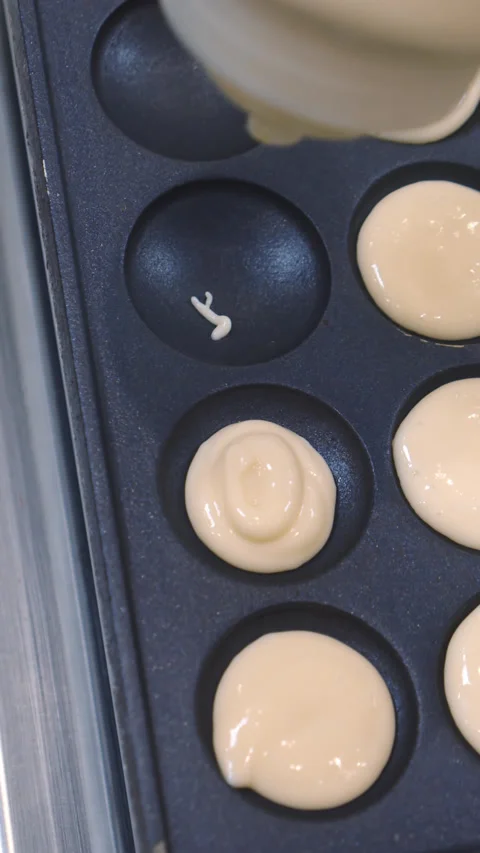 Mini pancake toaster. Process for making a mini pancakes. Stock Footage 178997873