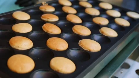 Mini pancakes are cooked in a special pan at a children's party Stock Footage 278997362