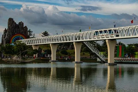 Mini park train riding on a small decorative bridge Stock Photos