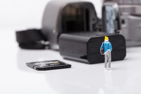 Mini people model checking digital camera for travel Stock Photos