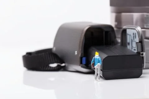Mini people model checking digital camera for travel Stock Photos