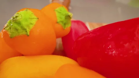 Mini Peppers Pull Back Above Slide on Cutting Board Macro Stock Footage 156054633