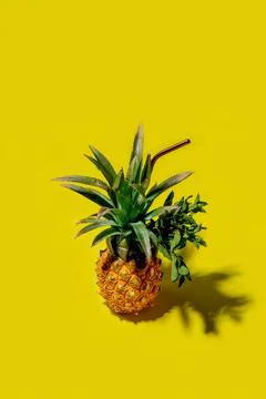 Mini pineappl on a solid yellow background Foto stock