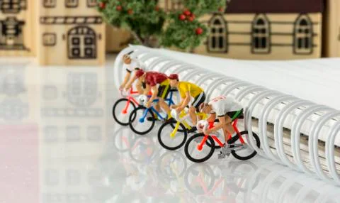 Mini puppets cycling game Stock Photos