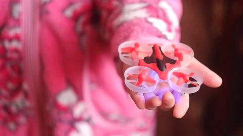 Mini quadcopter in the palm of a child.  Stock Footage 151606174