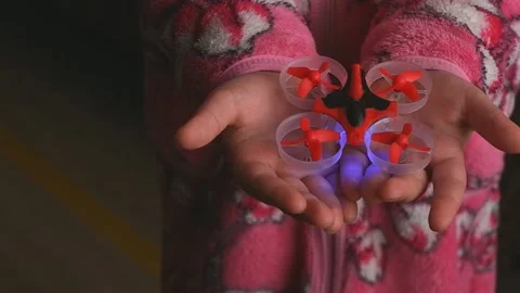 Mini quadcopter in the palm of a child. take off a mini drone from the hand.  Stock Footage 151606120