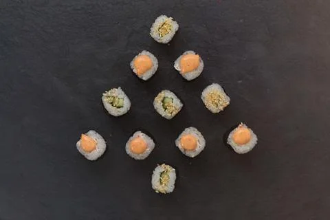 Mini rolls are lined with Christmas trees . Rice, cucumber, sesame, avocado Stock Photos