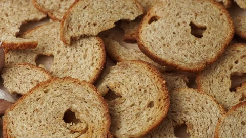 Mini rolls of baked bread and garlic isolated on wooden background Stock Footage 200930319