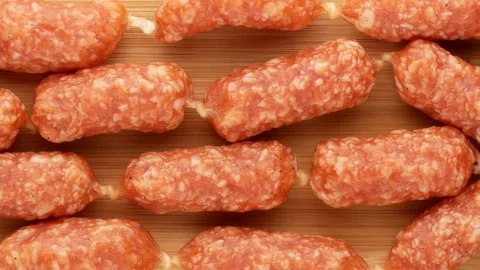 Mini sausages on the kitchen board, dolly shot. Stock Footage 143815099